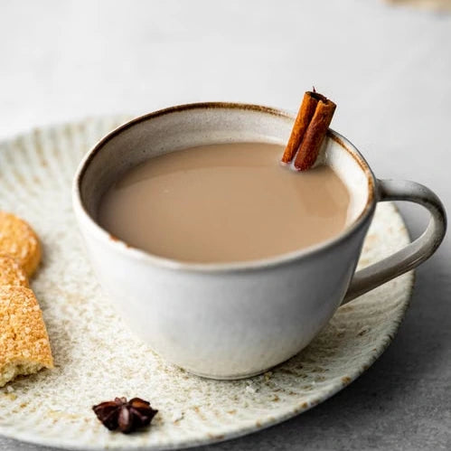 Chai latte in a ceramic cup with cinnamon — illustrative serving or coffee study